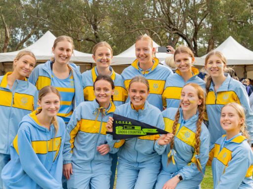 The St Hilda's cross country squad celebrating as a team